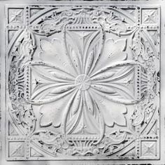 an intricately designed ceiling tile in white