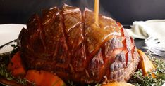 a large meat covered in sauce sitting on top of a plate