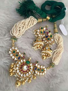 *It Is Handmade Gold Plated Indian Kundan Jewelry Necklace and Earrings Set. *It is 22 K Gold Plated necklace made from Silver and Copper-Mix material and also using handcut stones. *It is a beautiful Ethnic Indian Wedding Choker with Statement Earrings. *Its Earrings are 2.5 Inches Long. *Necklace and Earrings are same as in picture. *It will come with adjustable string which fits all Neck size. *Our all jewelry is made from semiprecious stones and beads. *WARRANTY: ITS GENUINE HANDMADE JEWELRY White Pendant Necklace With Matching Earrings, Elegant Multicolor Latkans Necklace, White Necklace With Latkans As A Gift, Traditional Jewel Earrings For Celebration, Traditional Jeweled Earrings For Celebration, Traditional White Jeweled Necklace, Traditional White Jewelry With Jewels, White Pendant Jewelry Sets For Festive Occasions, Festival Necklace Set With Matching Earrings And Round Shape