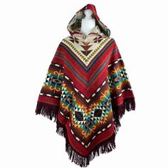 Stay cozy and stylish this fall and winter season with this stunning outerwear piece. This beautiful hooded poncho is the perfect addition to your wardrobe, combining the best of traditional poncho design with a modern twist. Handcrafted with love, this cloak is made from high-quality wool fabric, ensuring warmth and comfort in chilly weather. Its versatile style makes it ideal for both casual and formal occasions, and it can be easily paired with your favorite jeans or dresses. Embrace your inn Bohemian Hooded Brown Poncho, Winter Multicolor Poncho With Tassels, Multicolor Tassel Poncho For Winter, Red Bohemian Poncho Cape, Red Bohemian Cape Poncho, Cozy Winter Poncho With Fringe, Bohemian Hooded Poncho For Fall, Red Bohemian Poncho With Fringe, Red Shawl Cape For Fall