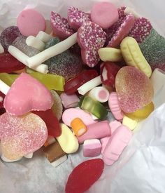 there are many different types of candies on the paper bag and one is pink