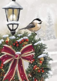 a bird sitting on top of a christmas wreath next to a street light with a red bow