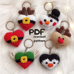 crochet keychains with different types of hearts and faces are shown on a white fur surface