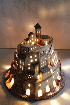 a cake made to look like a castle with lit candles