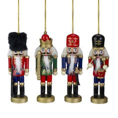 three wooden nutcrackers are hanging from strings