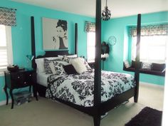 a black and white bed in a bedroom with blue walls