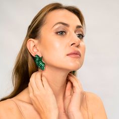 Get ready to feel enchanting with our dazzling Emerald Green Crystal Wing Earrings! Handmade with precision, these statement earrings feature vibrant emerald green crystals and a whimsical winged design. Perfect for any occasion, they add a touch of sophistication and glamour to your outfit. Lightweight and comfortable, they are ideal for all-day wear. Elevate your style with our exquisite Emerald Green Crystal Wing Earrings and make a bold statement that will leave everyone in awe! Size: Length Green Drop Earrings For Evening, Emerald Drop Earrings For Party, Trendy Green Crystal Earrings For Gift, Glamorous Green Earrings, Trendy Green Earrings For Evening, Glamorous Green Crystal Earrings, Green Crystal Drop Earrings For Evening, Glamorous Green Crystal Earrings For Party, Emerald Green Crystal