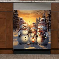 three snowmen standing next to each other in front of a wall with a lantern on it