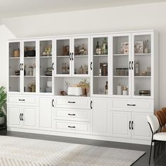 a large white bookcase with lots of glass doors and drawers in a living room