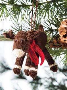 a stuffed animal ornament hanging from a christmas tree