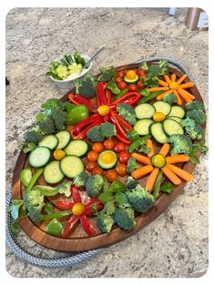 a wooden platter filled with lots of veggies