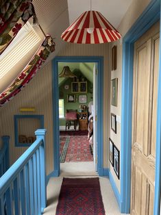 the hallway is decorated in blue and red with an umbrella hanging from it's ceiling