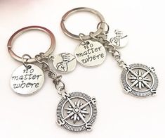 three key chains with two different charms attached to them, one has the words no matter where