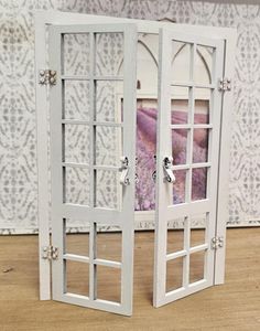 two white doors open on top of a wooden table