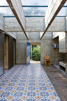 an empty room with blue and white tiles on the floor