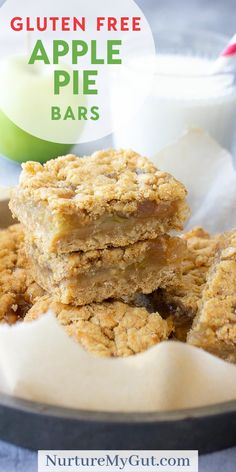 gluten free apple pie bars stacked on top of each other in front of a glass of milk