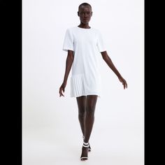 New With Tag. Outer Shell: 100% Polyester. Lining: 100% Polyester. Color: White White Pleated Dress For Daywear, Chic White A-line Pleated Dress, Chic White Dress With Pleated Hem, White Pleated Midi Dress For Daywear, White A-line Pleated Dress For Spring, White Pleated Midi Dress With Short Sleeves, White Fitted Pleated Workwear Dress, White Fitted Pleated Dress For Work, White Short Sleeve Mini Dress For Work