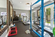 a home gym with exercise equipment and mirrors