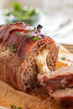 stuffed bacon cheese meatloaf on a cutting board with text overlay that reads stuffed bacon cheese meatloaf