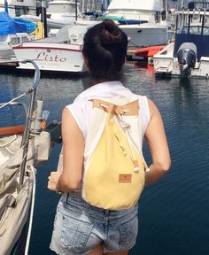 "The yellow beach bag is beautifully designed to be used as a backpack in any occasion. This sailor bag has a main compartment with a small interior pocket and an external zippered hidden pocket very useful to access keys, wallet or cellphone on the front of the bag and on the back. It has also a leather top closure with adjustable  straps.   This stylish sailor bag is a lightweight backpack perfect to carry your belongings anywhere you go! Length 10\" x Height 17\" Width 9\"/ 25 cm x 43 cm x 23 cm Overview: Handmade in Argentina Materials: Full grain leather and cotton canvas For summer and stylish beach tote bags visit: https://www.etsy.com/listing/505674980/navy-stripes-beach-tote-in-cotton-canvas?ref=shop_home_active_3 For Stylish and unique bicycle bags visit my other shop Bicibybar: Standard Backpack For Summer Outdoor Activities, Summer Outdoor Activities Backpack, Summer Outdoor Activities Standard Backpack, Yellow Backpack For School In Summer, Yellow Summer School Backpack, Summer Travel Backpack In Cotton, Yellow Summer Travel Backpack, Yellow Summer Backpack For Everyday Use, Yellow Backpack For Everyday Summer Use