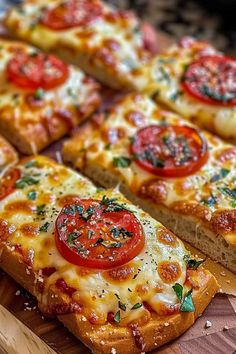 slices of pizza with tomatoes and cheese on a cutting board