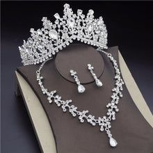 a tiara and jewelry set on top of a book