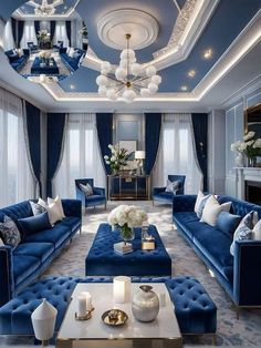 a living room with blue couches and chandeliers on the ceiling is lit by candles