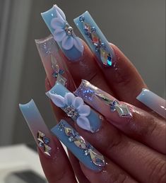 Long Acrylic Nails Coffin With Gems, White Nails With Designs With Diamonds, Long Blue Nails With Design, Nail Designs For Quinceanera Blue, Nail Ideas Mexican Style, White With Blue Quinceanera Dresses, Cinderella Theme Quinceanera Centerpieces Table Decorations, Royal Blue Acrylic Nails 3d Flower, French Blue Quince Theme