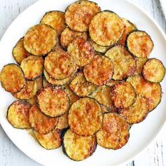 a white plate topped with cooked zucchini