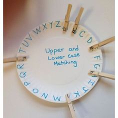 a paper plate with clothes pins attached to it that says upper and lower case matching