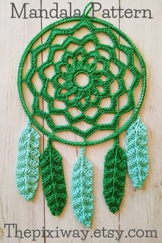 a green crocheted dream catcher with leaves