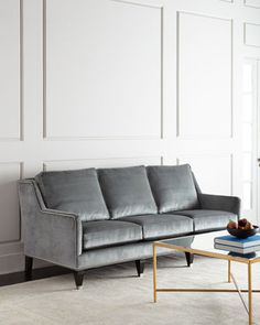 a living room with a gray couch and coffee table