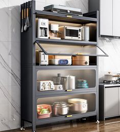 a kitchen with an oven, microwave and other items on it's shelves in front of a marble wall