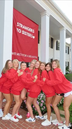 a group of women in red shirts posing for a photo