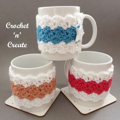 three coffee mugs with crochet on them are sitting next to each other