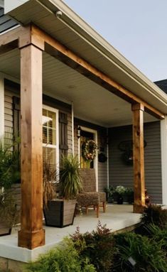 the front porch is covered with wooden posts