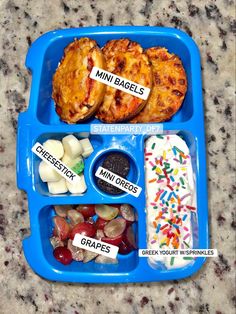 a blue tray filled with different types of food