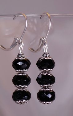 Black Vintage Style Earrings with Silver Filigree Accents. That are 1 1/2 inches long. All orders come in a gift box or a gift bag. Elegant Adjustable Pierced Plug Earrings, Elegant Adjustable Dangle Clip-on Earrings, Elegant Nickel-free Dangle Beaded Earrings, Elegant Nickel Free Dangle Beaded Earrings, Classic Party Earrings With Lever Back, Elegant Adjustable Plug Earrings For Party, Elegant Black Beaded Earrings, Elegant Black Round Bead Earrings, Classic Handmade Earrings For Party