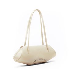 Handcrafted shoulder baguette bag. Constructed from supple, buttery pebble-grain leather with no hardware and a magnetic closure. -Shell: Supple Pebble Leather; Lining: Cotton Twill -Shipped in Dust Bag Made from Archival Textiles -Width: 13 in / 33 cm -Height: 5 in / 12.7 cm -Depth: 2.75 in / 7 cm -Handle Drop: 9 in / 22.8 cm Complimentary ground shipping within the U.S. Family Planning: At MSA Ethos, we work to provide access to family planning education and services through their on-site hosp Evening Beige Soft Leather Baguette Bag, Cream Leather Baguette Bag For Travel, Luxury Cream Baguette Bag For Everyday, Luxury Cream Baguette Bag For Daily Use, Everyday Cream Leather Baguette Bag, Cream Leather Baguette Bag For Everyday Use, Evening Cream Baguette Bag, Cream Evening Satchel Baguette Bag, Cream Baguette Satchel For Evening