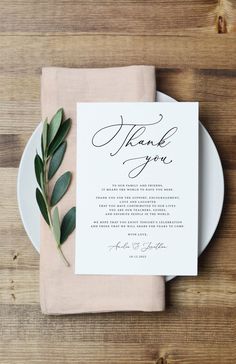 the wedding menu is displayed on a plate with an olive branch and greenery around it