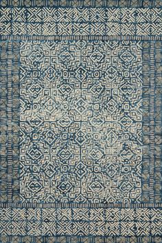 a blue and white rug with an intricate design on the bottom, surrounded by smaller squares