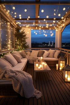 an outdoor living room with lights strung from the ceiling and pillows on the couches