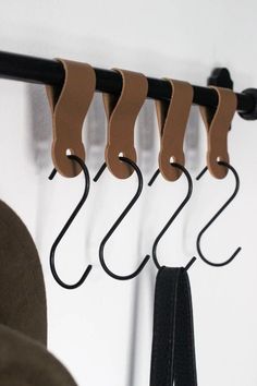 the coat rack has five coats hanging from it