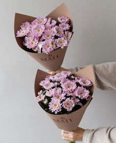 two women holding flowers in their hands