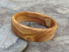 handmade Bracelet Bangle made out of fine olive wood Diameter inside 6,5 cm ( 2,56 inch) large 2 cm ( 0,79 inch) the olive wood is finely sanded and oiled with olive oil naturally the grain of the olive wood can vary from item to item , but in any case you will get a olive wood bracelet with beautiful grain This bangles are turned by us from a piece of olive wood. Handmade in Portugal In our Shop you can find more earrings , rings and necklaces made out of olive wood ! Nature-inspired Natural Color Bracelet As A Gift, Nature-inspired Natural Color Bracelet For Gift, Natural Artisan Bracelet As Gift, Artisan Natural Color Bracelets As A Gift, Artisan Natural Color Bracelet As Gift, Natural Bangle Bracelets As Gift, Natural Color Bracelet Jewelry Gift, Natural Color Bangle Bracelets As Gift, Natural Bangle Bracelets For Gifts