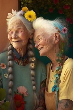 two older women with flowers in their hair, one is holding the other's head