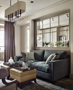 a living room filled with furniture and windows