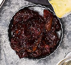 a pie tin filled with raisins next to two slices of cheese