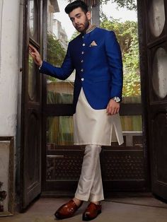 <p>Color: Dark blue<br />Fabric: Raw Silk<br />Stylish prince coat features rich quality embellishments accentuate on the collar<br />Fancy button closure<br />Comes with off-white kurta and pajama</p> <p> </p> <p><strong>Additional Accessories:</strong> </p> <p><strong>Plain Kolhapuri/Saleem Shahi shoes:</strong> US$30 (Made with prince coat material)</p> <p><strong>Note:</strong> Price of all prince coat suits includes only 3 pieces i.e. prince coat, kurta/kameez and shalwar/pajama (or whateve Elegant Blue Designer Outerwear, Elegant Nehru Jacket With Stand Collar For Designer Wear, Elegant Designer Nehru Jacket With Stand Collar, Designer Wear Elegant Bandhgala With Stand Collar, Elegant Designer Bandhgala With Stand Collar, Royal Traditional Wear For Eid, Embroidered Nehru Jacket For Diwali Semi-formal Occasions, Fitted Sherwani With Stand Collar For Diwali, Traditional Fitted Bandhgala With Button Closure