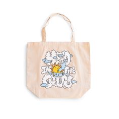 front view image of tote bag from Bather that reads head in the clouds in bubbled text with a drawing of a sun in the middle Travel Cotton Tote Beach Bag, Beige Cotton Canvas Bag For Vacation, Cotton Beach Bags For Daily Use, Beige Cotton Beach Bag For Travel, Cotton Shoulder Bag For Daily Use At Beach Season, Eco-friendly Cotton Tote Beach Bag, Eco-friendly Canvas Weekend Bags, Summer Weekend Cotton Beach Bag, Beige Cotton Vacation Bag